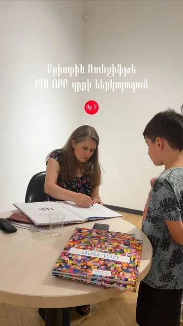 Mayrik author signing a book