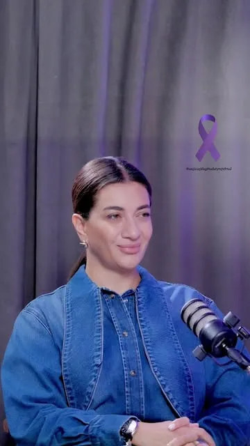 Domestic violence awareness interview with a purple ribbon