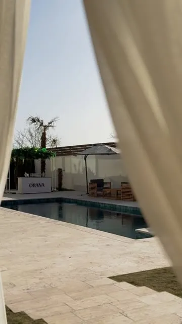 Ohana pool framed by curtains
